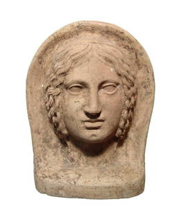 A wonderful Etruscan terracotta votive head of a woman: A wonderful Etruscan terracotta votive head of a woman, 4th - 3rd Century BC, in beautiful high relief with detailed features, her hair parted behind a narrow diadem and falling in curled locks into