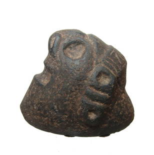 A choice Taino carved stone Death Head: A choice Taino carved stone Death Head, c. AD 1000 - 1500, of hard volcanic basalt and carved in remembrance of a loved one with nice style and wearing a geometric headband. These were kept in the