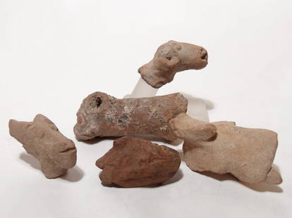 Ancient terracotta animal fragments from the Holy Land: A lot of ancient terracotta animal fragments from the Holy Land. Lot includes three heads from animal figures, c. 1500 - 800 BC, and includes a ram with curled horns, a goat and a long necked animal,