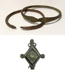 A pair of Western Asiatic bracelets and a Roman brooch: A pair of Western Asiatic bracelets and a Roman brooch. Lot include a pair of Western Asiatic bronze bracelets, c. 1000 - 500 BC, the first a snake bracelet, the terminals in the form of two serpent