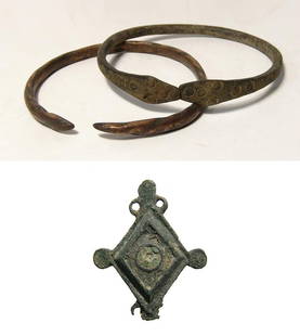 A pair of Western Asiatic bracelets and a Roman brooch: A pair of Western Asiatic bracelets and a Roman brooch. Lot include a pair of Western Asiatic bronze bracelets, c. 1000 - 500 BC, the first a snake bracelet, the terminals in the form of two serpent h