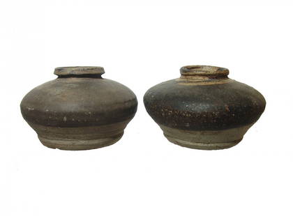 A pair of Chinese glazed jars, Song Dynasty: A pair of Chinese glazed jars, Song Dynasty, 13th - 14th Century, each squat with wide, stable foot and narrow mouth, likely ink storage vessels. 2 3/8 x 4 in (6 x 10.2 cm) & 2 ½ x 3 7/8 in (6.3 x