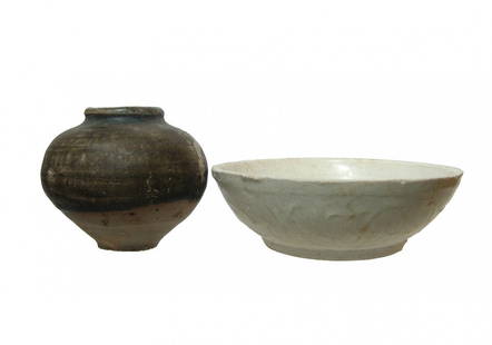 A Chinese celadon bowl and a glazed jar: A Chinese celadon bowl and a glazed jar. Lot includes a Chinese celadon tea bowl, Song or Yuan Dynasty, AD 960 - 1279, with floral decoration in relief around the outside, Dia: 4 ¼ in (10.7 cm).