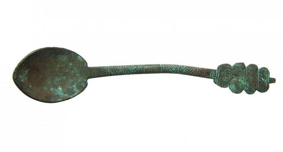 An Islamic bronze spoon, Eastern Mediterranean: An Islamic bronze spoon, Eastern Mediterranean, c. 11th - 15th Century, of solid construction with incised decoration on the shaft and terminal. L: 7 ¾ in (19.8 cm). Nicely patinated. Ex Gagne
