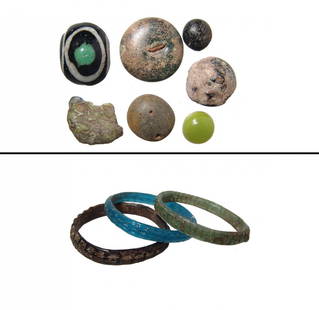 A group of Roman glass bracelets and counters: A group of Roman glass bracelets and counters, c. 1st - 5th Century AD. Lot includes 3 Roman glass bracelets, one in translucent turquoise blue glass, another in opaque black glass and the third in
