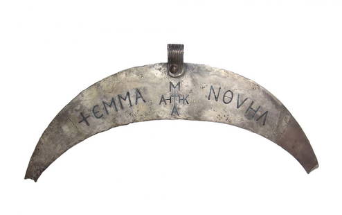 Byzantine silver & niello crescent ceremonial pectoral: A Byzantine silver and niello crescent ceremonial pectoral, c. 7th - 9th Century AD, with inlaid lettering reading '+EMMA NOVHA with a central monogram, central loop for suspension with vertical