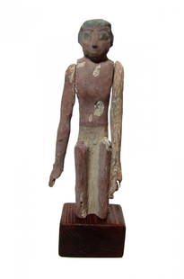 A nice Egyptian painted wood figure, Middle Kingdom: A nice Egyptian painted wood figure, Middle Kingdom, c. 2061 - 1690 BC, from a large model wood boat or a scene from daily life. He is depicted seated with carved face and black cosmetic details. He