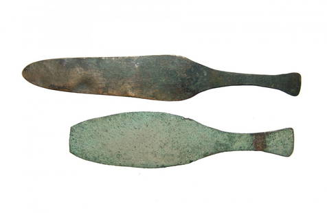 A rare pair of Egyptian bronze knives, New Kingdom: A rare pair of Egyptian bronze knives, New Kingdom, c. 1570 - 1075 BC, a type as Flinders Petrie described as ‘almost peculiar to Egypt’, each formed from sheet metal, the blade pounded flat with