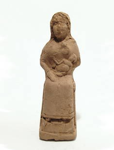 An Old Babylonian terracotta seated woman: An Old Babylonian terracotta seated woman, c. 1900 - 1750 BC, the woman sits on her throne suckling an infant who she cradles with her left arm, in the manner of the goddess Isis who suckles the