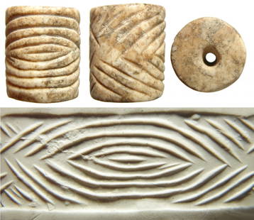 A nice Jemdat Nasr creme marble cylinder seal: A nice Jemdat Nasr creme marble cylinder seal, c. 3200 - 2700 BC, well-carved with a large protective eye motif. 21 x 17 mm. Mottled deposits and a classic motif! Ex Joel Malter collection; Ex Los Ang