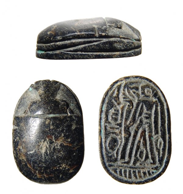Egypt. 2nd Intermediate Period, c.1650 – 1549 BC. : Egypt. 2nd Intermediate Period, c.1650 – 1549 BC. Black steatite. Simplistic style and good color. On base, god standing amidst symbols of power. 19x13mm.