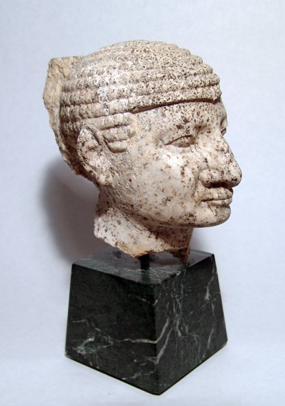 Egyptian stone head. Ex-Saint Louis Art Museum: A speckled granite head of a man wearing tight fitting Nubian wig, Old Kingdom, c.2625 - 2130 BC, his facial features very naturalistic, with large nose, wide eyes and pursed lips. Remains of plinth a