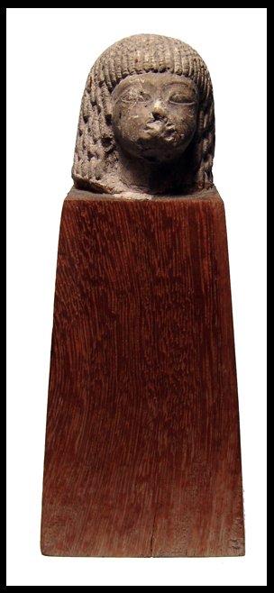 Egyptian limestone head from a funerary statue: A detailed limestone head from a funerary statue wearing a Nubian wig and with very slanted eyes. Style resembles sculpture from the reign of Amenhotep III of the 18th Dynasty, c.1386 - 1349 BC. Some