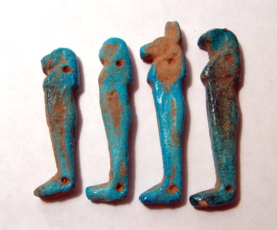 Lot of four Egyptian "sons of Horus" figures: A lot of four "sons of Horus" figures, Late Period, c.664 - 30 BC, each pierced for stitching to the bandages of a mummy. Each is intact and clearly represents one of the four deities that protected t