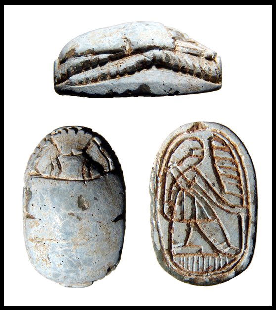 Steatite scarab, kilted male holding palm frond: A well carved light blue steatite scarab, 2nd Intermediate Period, c.1650 - 1549 BC. Levantine. Nicely carved head and deeply feather legs. On base, kilted male figure holding a palm frond. 21x14mm. E