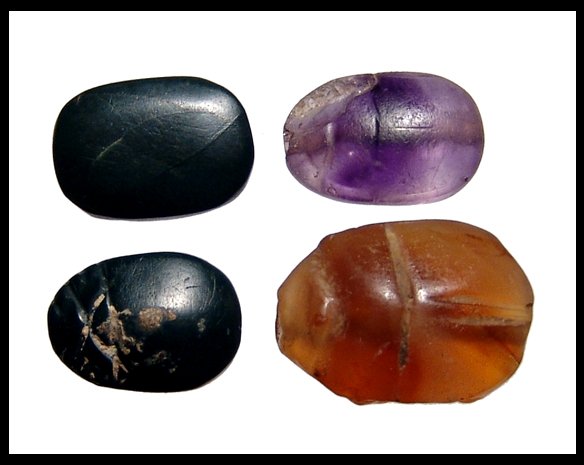 Lot of 4 hard stone scarabs. Ex Negus collection: A nice lot of 4 hard stone scarabs. The first is a Middle Kingdom amethyst scarab, 13x8mm, the second a carnelian scarab from the New Kingdom, with well carved body, 18x12mm, and the last two of green