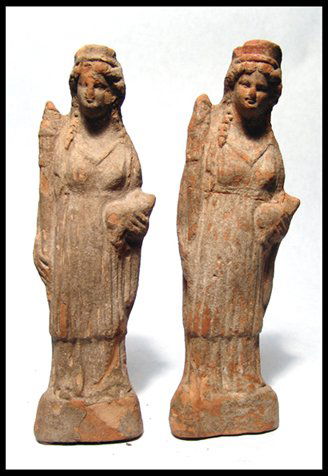 Magnia Graecia, pair of terracotta women: A pair of molded terracotta women, Magnia Graecia, 3rd - 2nd Century BC, both from the same mold! Both are free standing on an integral raised base with a diadem and chiton and holding a torch? and a