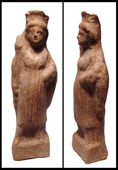 Magnia Graecia, molded terracotta lady: A molded terracotta lady, Magnia Graecia, 3rd - 2nd Century BC, free standing on an integral base with a diadem and chiton and holding a torch? and a small piglet. Vent hole at back. Intact. H: 7 1/8"