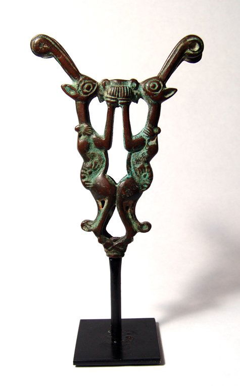Western Iran, Luristan bronze finial, two goats: A Luristan bronze finial in the form of two rampant goats, Western Iran, c.1200 - 1000 BC, each clutching the side of a cup. Nice style and light green patination over glossy brown. H: 5" (12.5 cm). M