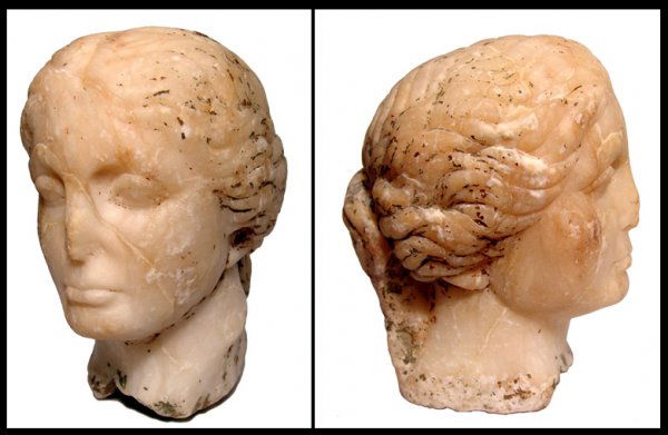 Roman marble head of a goddess: A marble head of a goddess, Roman, 2nd - 3rd Century AD, hair pulled back in waves into a queue at the back of her head. Her features are softly rendered with some minor loss to the nose and some pitt