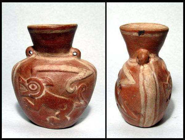Lovely Moche molded flask from Peru: A lovely Moche molded flask from Peru, c. AD 550 - 700. This fine redware example is decorated with two depictions of the Crested Animal, molded in high relief and enhanced with cream pigment. H: 4 3/