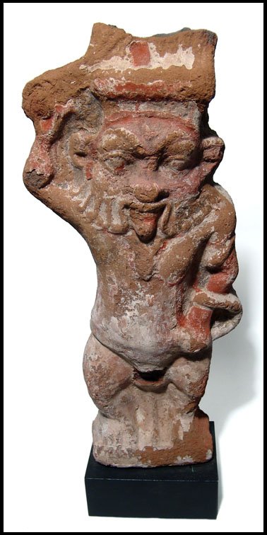 Egypt. Large painted plaque with the god Bes: A large painted plaque with the god Bes, Late Period - Ptolemaic, c.4th - 3rd Century BC. He stands, wielding a sword in his raised right hand, the weapon crossing the feathers of the crown. In his lo