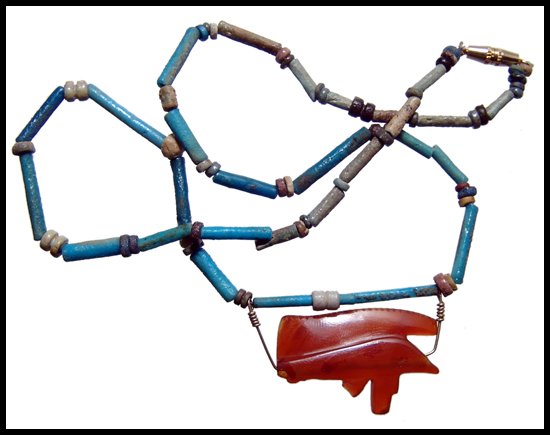 Faience bead necklace with carnelian Eye of Horus: A nice faience bead necklace with carnelian Wedjat or Eye of Horus, Late Period, c.664 - 30 BC. Strung with multicolored faience tube beads with disc bead spacers with the carnelian amulet attached wi