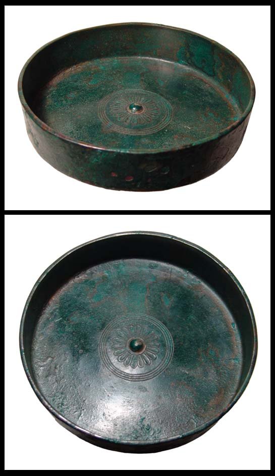 Syria. Beautiful bronze phiale. Ex Seaby, London: A beautiful bronze phiale, Syrian, c.5th - 4th Century BC, with small central omphalos surrounded by petal flutes. Intact with a lovely glossy deep olive green patina. D: 7 1/8" (18.1 cm). Ex JME Coll