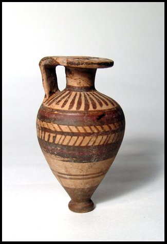 Archaic Greek Proto-Corinthian Aryballos: A Proto-Corinthian Aryballos, Archaic Greek, c.650 - 600 BC, decorated with dark red and brown bands and herring bone design. Some repair on handle and a few minor chips. H: 3 3/8" (8.6 cm). Ex old Ir