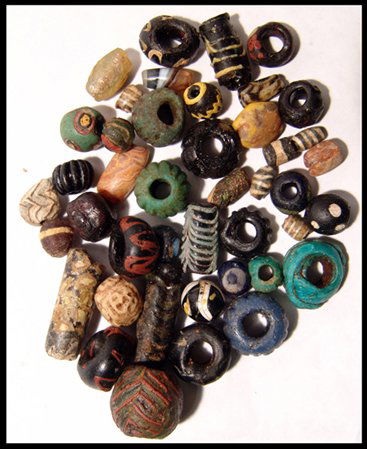 A large group of 43 Near Eastern glass beads: A large group of 43 Near Eastern glass beads, Hellenistic through Islamic, with many types and colors. A few of the beads are of stone. A fun group! Ex Los Angeles collection.