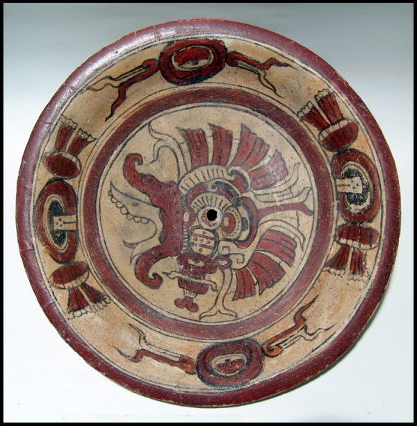 Large Maya plate from Peten area of Guatemala: A large Maya plate from the Peten area of Guatemala, c. AD 600 - 900, featuring a depiction of a bearded Dragon or War Serpent in its center. The painting is highly detailed and is surrounded by a bro