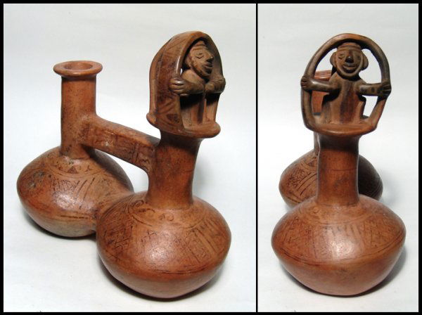 Inca seated shaman whistle bottle from Peru: An exceptional Inca whistle bottle from Peru, c. AD 1300 - 1500, featuring a shaman seated in a spirit hut. The chambers, bridge and hut exterior are covered with intricate designs executed in the neg