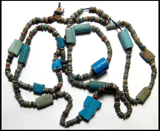 Long strand of multicolored faience disc beads: Ancient Egypt. A long strand of multicolored faience disc beads, Late Period, c. 664 - 30 BC. The beads are of good quality and strung with 14 other large faience beads, mostly thicker tube types. Len