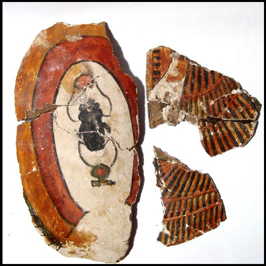 Three cartonnage fragments from a burial mask: Ancient Egypt. A group of three cartonnage fragments from a burial mask, Ptolemaic, c.3rd - 1st Century BC, including a portion of the top depicting the kheper with solar disc before and a "shen" or e