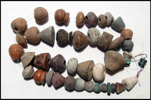 Fine strand of ancient spindle whorls from Peru: A fine strand of ancient spindle whorls from various Peruvian cultures. The strand contains 42 whorls, a wide variety of nice examples including clay, copper, shell and stone types. A nice collection