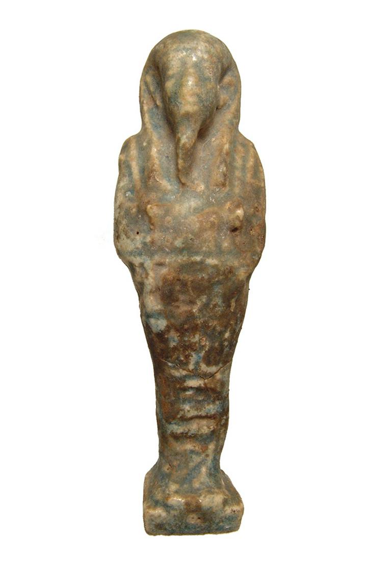 A large Egyptian faience ushabti, Late Period: A large Egyptian faience ushabti, Late Period, c. 664 - 332 BC, depicted mummiform on integral base, wearing tripartite wig and false beard, arms folded at chest, hands holding a pick and hoe, basket 