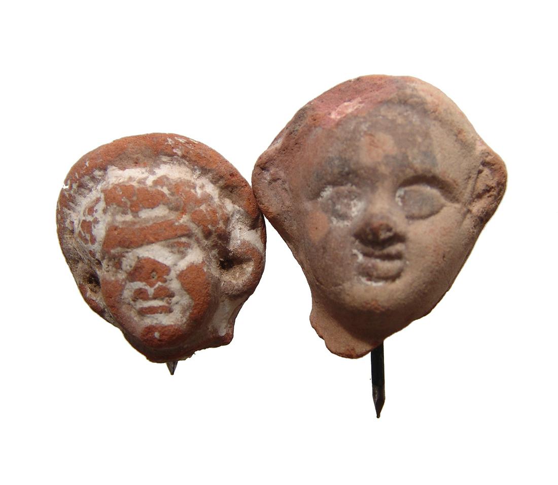 A lot of Romano-Egyptian terracotta heads: A lot of Romano-Egyptian terracotta heads, 1st - 2nd Century AD, the first depicting a woman in headdress and the second depicting a man. Largest: 1 5/8 in (4.2 cm) in heights. Ex Harvith collection, 