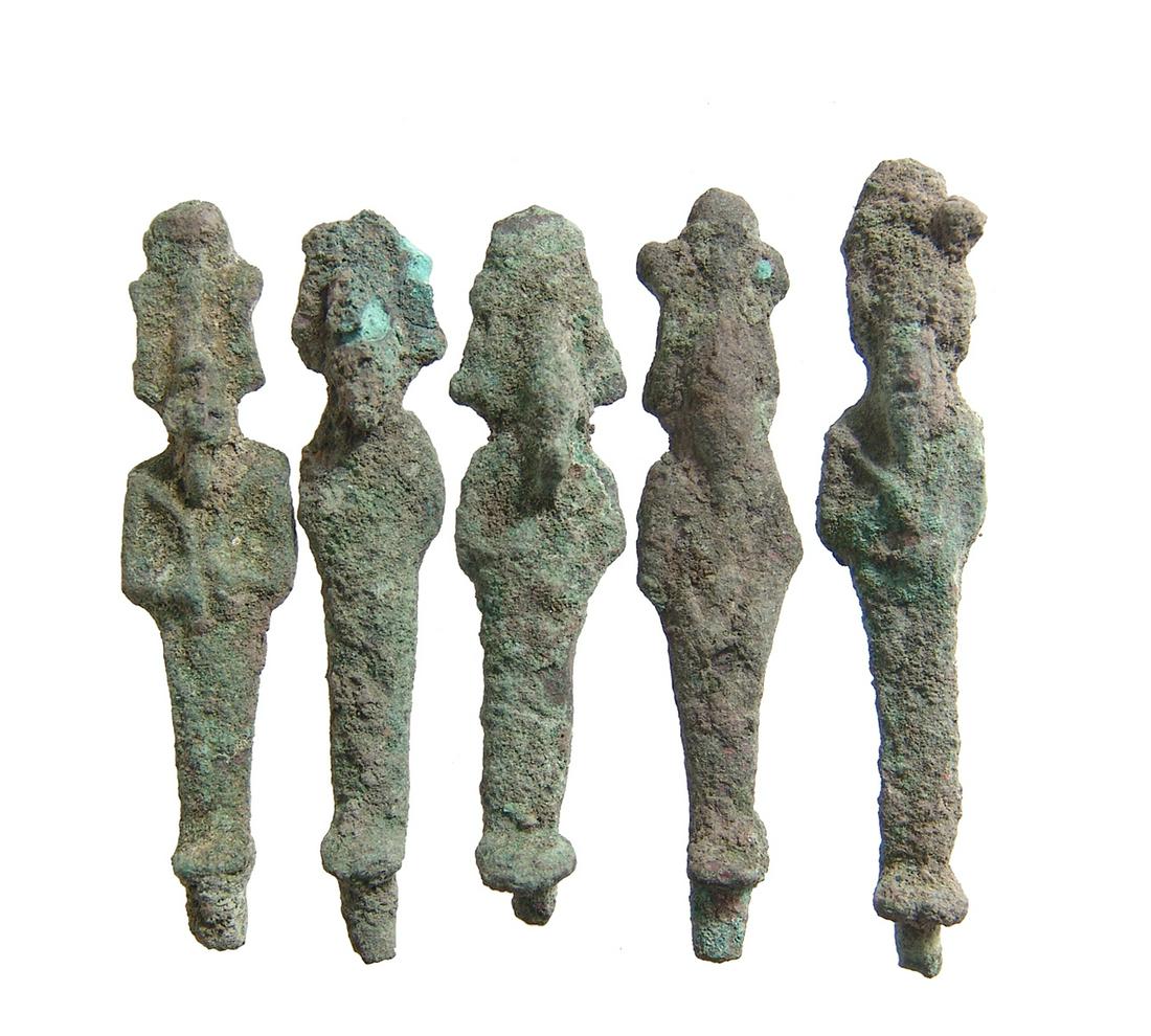 A lot of 5 Egyptian bronze votive figures of Osiris: A lot of 5 Egyptian bronze votive figures of Osiris, Late Period, c. 664 - 332 BC, each depicted mummiform, wearing Atef crown with uraeus and false bead, arms folded over chest and holding a crook an