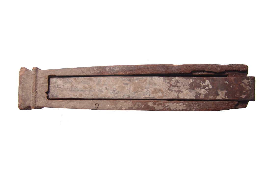 An Egyptian wooden animal sarcophagus: An Egyptian wooden animal sarcophagus, Ptolemaic Period, c. 332 - 30 BC, for perhaps a serpent, fashioned in the form of a shrine with long, sliding panel. The entire piece is carved from a single pie