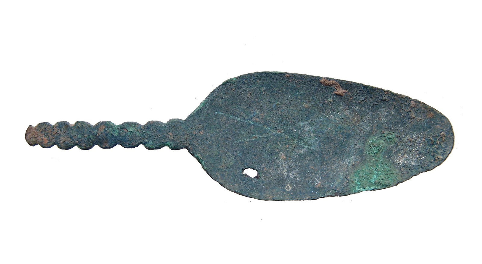 An Islamic bronze spoon: An Islamic bronze spoon, c. 10th - 14th Century, the bowl of stretched ovoid shaped with decorative handle that likely fit into a more substantial handle in another material. L: 5 3/8 in (13.6 cm). En