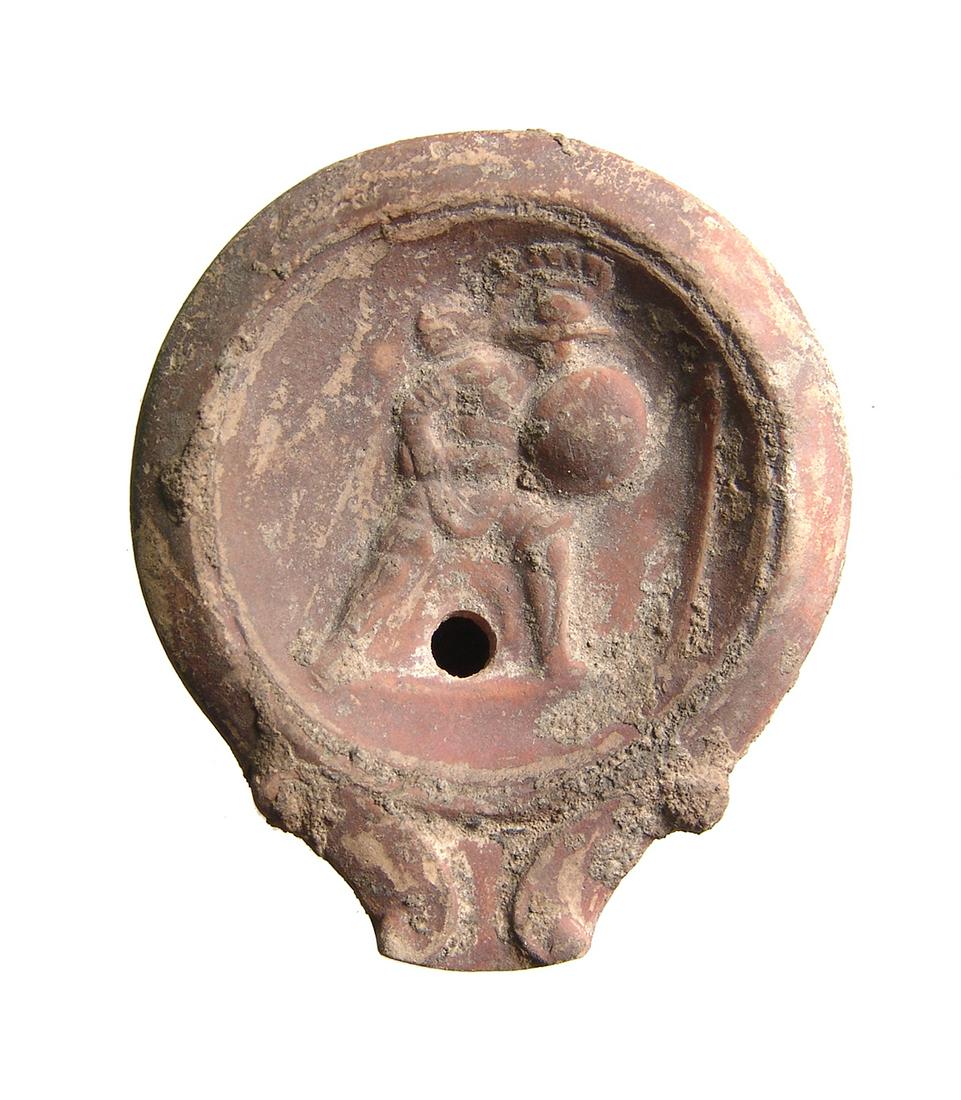 A Roman discus oil lamp depicting a gladiator (1 of 2)