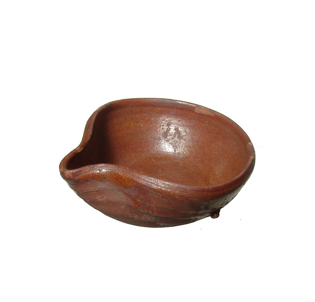 An Islamic glazed pinched lamp: An Islamic glazed pinched lamp, c. 9th - 12th Century AD, well-preserved with glossy brown glaze. 3 3/8 x 3 1/4 in (8.6 x 8.3 cm). Ex collection of T.J. Morrison, N.H.; Ex New York private collection 