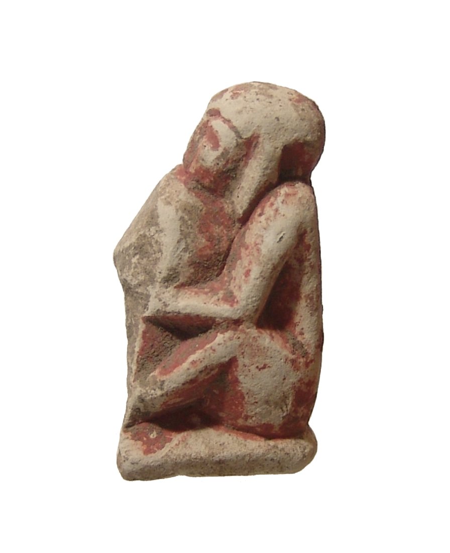 An Egyptian limestone figure of a seated figure (1 of 4)
