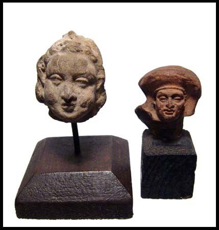 Pair of attractive Greek terracotta heads,: A pair of attractive Greek terracotta heads, 3rd – 1st Century BC, one with a youthful cherub-like face and the other stern male wearing a diadem. H: 1 1/2" (3.8 cm) & 1 3/4" (4.3 cm). Both mounted