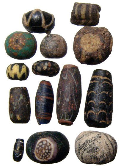 Lot of 14 glass beads, Greek - Islamic: A lot of 14 glass beads, Greek - Islamic, Eastern Mediterranean, c. 1st Century BC to 9th Century AD. A wide mix of polychrome types including combed, speckled and mosaic. Largest bead measures 29 mm
