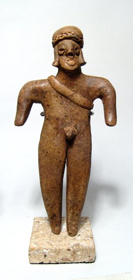 Excellent Colima male figure, West Mexico: An excellent Colima figure West Mexico, c. 300 BC – 300 AD. This standing male is 7" tall and is adorned with a sash and fancy headdress. Good dendrites overall. Mounted on stand.