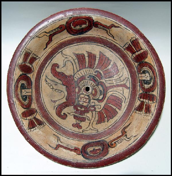 Large Maya plate, Peten area of Guatemala: A large Maya plate from the Peten area of Guatemala, c. AD 600 – 900, featuring a depiction of a bearded Dragon or War Serpent in its center. The painting is highly detailed and is surrounded by a b