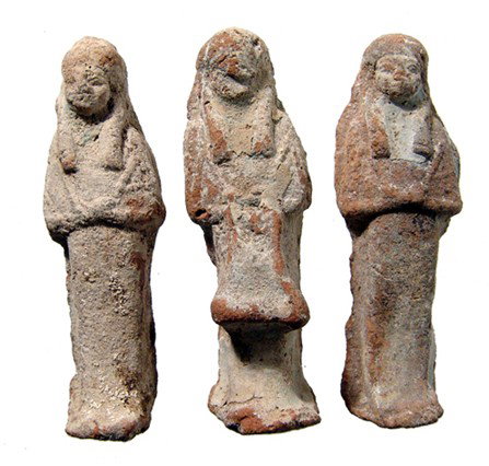 Egyptian Group of 3 molded terracotta ushabtis: A group of 3 molded terracotta ushabtis, Late Period, c. 664 - 30 BC, one of which is an overseer or "reis" ushabti. Each is intact with white dressing. Each about 3 1/8" (8 cm) in length.