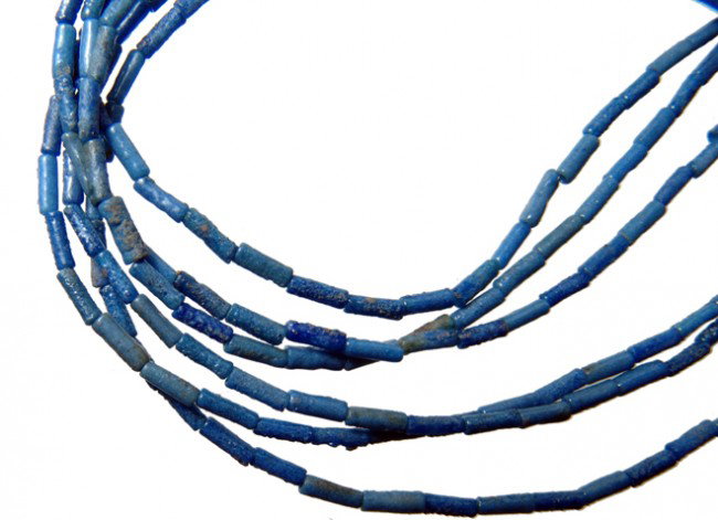 Egypt Necklace of cobalt blue faience tube beads: A beautiful necklace of cobalt blue faience tube beads, Late period, c.664 - 30 BC, handsomely strung with two modern lotus-shaped elements and a silver clasp. Design is a single strand splitting into