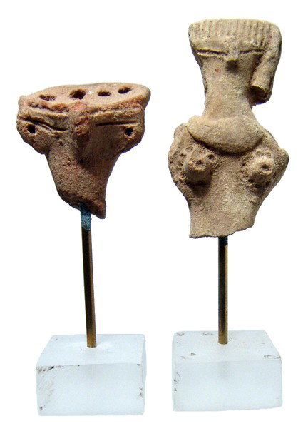 Terracotta heads from Egyptian fertility figures: A pair of terracotta heads from Egyptian fertility figures, 2nd Intermediate Period, 1750 - 1570 BC, each is nicely modeled with the characteristic bird-like features. One with four holes through the 